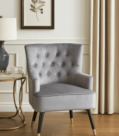 Tufted grey upholstery. Luxe chairs. Contemporary design. Plush cushioning. Boutique style. Gold finish tipped feet. Living room. Furniture. Home decor. Seating. Statement piece. Elegant. Comfortable. Stylish. Durable. High-quality materials. Modern classic. Sophisticated. Black legs. Gold tips. Unique design. Versatile. Timeless. Eye-catching. Velvet. Mira.