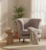 Emilia velvet chair. Scalloped accent chair. Velvet upholstery. Luxe chair. Gold finish legs. Black wood legs. Blue velvet. Pink velvet. Grey velvet. Mink velvet. Plush cushioning. Boutique style. Contemporary chair. Stylish seating. Home furniture. Living room chair. Decorative chair. Elegant furniture. Modern accent chair. Trendy home decor. Comfortable seating. Luxury chair. Designer chair.