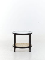 Manila Side Table. Modern minimalism. Black elm wood frame. Clean lines. Rounded corners. Clear glass top. Natural cane open weave. Organic appeal. Sustainable frame. Natural rattan weave. Organic simplicity. Mid-century modern. Stylish. Functional. Living room. Hallway. Bedroom. Durable. Elegant design.