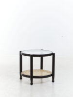 Manila Side Table. Modern minimalism. Black elm wood frame. Clean lines. Rounded corners. Clear glass top. Natural cane open weave. Organic appeal. Sustainable frame. Natural rattan weave. Organic simplicity. Mid-century modern. Stylish. Functional. Living room. Hallway. Bedroom. Durable. Elegant design.