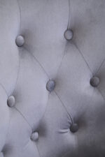 Tufted grey upholstery. Luxe chairs. Contemporary design. Plush cushioning. Boutique style. Gold finish tipped feet. Living room. Furniture. Home decor. Seating. Statement piece. Elegant. Comfortable. Stylish. Durable. High-quality materials. Modern classic. Sophisticated. Black legs. Gold tips. Unique design. Versatile. Timeless. Eye-catching. Velvet. Mira.