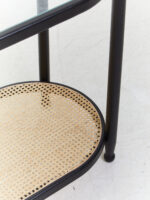 Elm wood. Console table. Modern minimalism. Black finish. Clean lines. Rounded corners. Clear glass top. Lower shelf. Natural cane. Open weave. Sustainable frame. Natural rattan. Organic simplicity. Mid-century modern. Stylish. Functional. Living room. Hallway. Entryway. Durable. Elegant design. Furniture. Home. Display.
