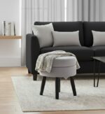 Lila footstool. Velvet footstool. Upholstered footstool. Luxury footstool. Modern footstool. Plush footrest. Boutique furniture. Blue footstool. Grey footstool. Mink footstool. Burgundy footstool. Wine red footstool. Velvet furniture. Contemporary footstool. Small ottoman. Velvet ottoman. Stylish footstool. Soft seating. Home accessories. Bedroom furniture. Living room furniture. Accent furniture. Modern interior. Black wooden legs. Cushioned stool. Velvet accent piece. Compact seating solution.