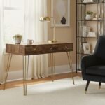 Talia desk. Mid-century modern desk. Wood veneer desk. Writing desk. Home office furniture. Stylish desk. Modern desk. Three drawer desk. Hairpin leg desk. Wooden desk. Contemporary furniture. Retro desk. Brown desk. Compact home desk. Warm metallic legs. Desk with storage. Vintage style desk. Small office desk. Wooden home office furniture. Metal leg desk. Storage solution. Classic desk design. Home study furniture. Workspace furniture. Rustic finish desk.