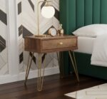 Talia bedside table. Wood veneer table. Mid-century bedside table. Modern bedside table. Hairpin legs. One drawer table. Bedroom furniture. Stylish storage. Neo-classical table. Compact side table. Wooden bedside unit. Warm wood finish. Metallic legs. Retro furniture. Small nightstand. Contemporary bedroom. Furniture with storage. Bedside drawer. Brown wood table. Accent table. Sleek design furniture. Designer bedside. Bedroom essentials. Space-saving furniture.