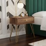 Talia bedside table. Wood veneer table. Mid-century bedside table. Modern bedside table. Hairpin legs. One drawer table. Bedroom furniture. Stylish storage. Neo-classical table. Compact side table. Wooden bedside unit. Warm wood finish. Metallic legs. Retro furniture. Small nightstand. Contemporary bedroom. Furniture with storage. Bedside drawer. Brown wood table. Accent table. Sleek design furniture. Designer bedside. Bedroom essentials. Space-saving furniture.