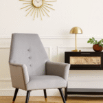 Camille velvet armchair. Grey armchair. Blue armchair. Velvet upholstery. Button detail. Gold-tipped legs. Black wooden legs. Luxe accent chair. Modern chair. Retro style. Boutique furniture. Plush cushioning. Living room chair. Home furniture. Stylish seating. Contemporary design. Velvet accent chair. Upholstered armchair. Comfortable seating. Decorative chair. Elegant furniture. Designer chair. Soft fabric chair. Trendy home decor. Modern living room furniture. Luxury chair. Blue velvet. Grey velvet. Wooden legs. Gold finish legs. Stylish armchair. Interior design furniture.