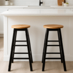 Bar stool. Kitchen stool. Wooden bar stool. Natural wood. A-frame legs. Black. White. Grey. Modern rustic furniture. Home furniture. Seating. Counter stool. Bar seating. Minimalist furniture. Scandi style. Farmhouse bar stool. Breakfast bar chair. Footrest stool. Compact bar stool. Solid wood stool. Contemporary seating.