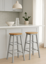 Bar stool. Kitchen stool. Wooden bar stool. Natural wood. A-frame legs. Black. White. Grey. Modern rustic furniture. Home furniture. Seating. Counter stool. Bar seating. Minimalist furniture. Scandi style. Farmhouse bar stool. Breakfast bar chair. Footrest stool. Compact bar stool. Solid wood stool. Contemporary seating.