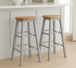 Bar stool. Kitchen stool. Wooden bar stool. Natural wood. A-frame legs. Black. White. Grey. Modern rustic furniture. Home furniture. Seating. Counter stool. Bar seating. Minimalist furniture. Scandi style. Farmhouse bar stool. Breakfast bar chair. Footrest stool. Compact bar stool. Solid wood stool. Contemporary seating.