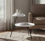 side table. 2 tier table. iron side table. minimalist furniture. black iron legs. white table. grey table. contemporary table. modern home décor. compact table. living room furniture. bedroom furniture. monochrome furniture. stylish side table. metal frame table. small space furniture. home accessories. interior design. functional furniture. sleek furniture.