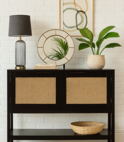 Nero Side Cabinet. Black furniture. Wood cabinet. Natural rattan panels. Storage solution. Two closed shelves. Undershelf. Modern home furniture. Warm aesthetic. Earthy tones. Contemporary design. Living room storage. Bedroom furniture. Stylish cabinet. Practical storage. Minimalist cabinet. Durable wood. Eco-friendly materials. Home organisation.