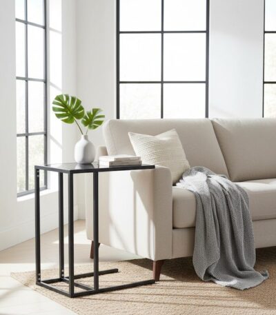 Axel Side Table. C-shaped side table. Black side table. Grey side table. Powder-coated metal. Modern side table. Minimalist furniture. Lightweight table. Living room furniture. Sofa side table. Contemporary home decor. Metal side table. Sleek design. Open sledge base. Durable side table. Small side table. Compact furniture. Space-saving table. Elegant side table. Home accessories.