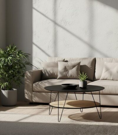 Dakota Coffee Table. Black metal table. Natural rattan shelf. Hairpin legs. Round coffee table. Storage shelf. Organic texture. Modern furniture. Natural living. Minimalist design. Home furniture. Living room table. Durable coffee table. Contemporary style. Black furniture. Rattan furniture. Sleek design.