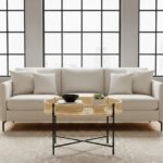 Dakota. Coffee Table. Natural Rattan. Hand Woven. Black Metal Base. Round Table. Cross Base. Organic Texture. Natural Living. Living Room Furniture. Home Decor. Sleek Design. Minimalist. Contemporary. Brown. Black. Natural Colors.