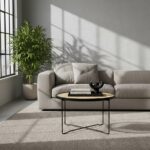 Dakota. Round coffee table. Natural rattan. Hand-woven rattan. Black metal base. Sleek design. Minimalist furniture. Organic texture. Natural living. Home furniture. Living room table. Modern coffee table. Durable. Stylish table.