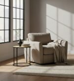 Dakota side table. Round side table. Natural rattan. Hand-woven rattan. Organic texture. Black metal legs. Sleek design. Minimalist furniture. Natural living. Home decor. Living room furniture. Modern side table. Contemporary furniture. Black finish. Rattan furniture. Lightweight table.