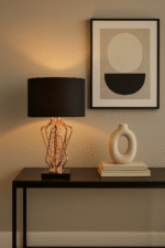 Stella Table Lamp. Home lighting. Black fabric shade. White fabric shade. Bronze metal frame. Black marble base. Handcrafted lamp. Contemporary design. Modern lighting. Decorative lamp. Table lamp. Living room lighting. Bedroom lighting. Stylish lamp. Elegant lighting. Durable lamp. Indoor lighting. Sleek design. Luxury lighting. Black and white shades. Bronze finish.