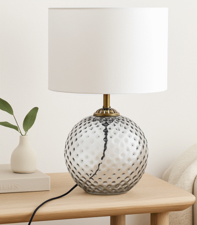 Home. Lighting. Table Lamp. Glass Lamp. Dimpled Glass. Modern Lighting. Contemporary Decor. Ambient Lighting. Accent Lighting. Fabric Shade. Gold Finish. Glass Base. Cylinder Shade. Grey Lamp. Aqua Blue Lamp. Clear Glass Lamp. Elegant Lamp. Bedroom Lighting. Living Room Lighting. Office Lighting. Luxe Lighting. Interior Styling. Soft Glow Lamp. Decorative Lighting. Minimalist Lamp. Translucent Lamp