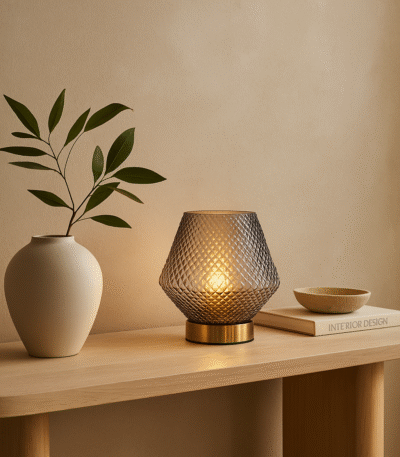 Vira Table Lamp. Glass table lamp. Embossed glass. Textured glass lamp. Gold finish base. Grey lamp. Aqua blue lamp. Clear lamp. Contemporary lighting. Modern table lamp. Home lighting. Ambient lighting. Decorative lamp. Living room lighting. Bedroom lighting. Stylish lamp. Metallic gold lamp. Interior decor. Lighting fixture.