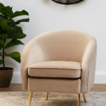 Esme Round Velvet Armchair. Velvet Armchair. Cream Velvet Chair. Mink Velvet Chair. Light Blue Velvet Chair. Mid-Century Modern Chair. Upholstered Armchair. High Density Foam Cushion. Plush Velvet Seating. Gold Metal Legs Chair. Stylish Accent Chair. Compact Armchair. Home Furniture. Modern Living Room Chair. Cozy Seating. Elegant Lounge Chair. Decorative Chair. Bedroom Chair. Office Accent Chair. Soft Velvet Upholstery. Comfortable Armchair. Tactile Texture Chair. Luxury Home Seating. Glamorous Chair.