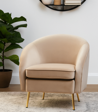 Esme Round Velvet Armchair. Velvet Armchair. Cream Velvet Chair. Mink Velvet Chair. Light Blue Velvet Chair. Mid-Century Modern Chair. Upholstered Armchair. High Density Foam Cushion. Plush Velvet Seating. Gold Metal Legs Chair. Stylish Accent Chair. Compact Armchair. Home Furniture. Modern Living Room Chair. Cozy Seating. Elegant Lounge Chair. Decorative Chair. Bedroom Chair. Office Accent Chair. Soft Velvet Upholstery. Comfortable Armchair. Tactile Texture Chair. Luxury Home Seating. Glamorous Chair.