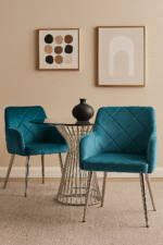 velvet dining chair. modern dining chair. padded seat. cocoon armrests. quilted backrest. gold finish legs. chrome finish legs. grey dining chair. aqua blue chair. black velvet chair. mid-century modern furniture. stylish dining seating. home furniture. dining room chair. luxury dining chair. contemporary dining chair. durable dining chair. compact dining chair. living space furniture. elegant dining chair. comfortable dining seating.