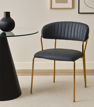 Taryn Faux Leather Dining Chair. Dark grey dining chair. Faux leather dining chair. Modern dining chair. Gold leg dining chair. Contemporary dining furniture. Padded dining chair. Tufted backrest chair. Minimalist dining chair. Ergonomic dining seating. Luxury grey dining chair. Easy clean faux leather chair. Metal frame dining chair. Stylish kitchen chair. Modern home office chair. Compact dining chair. Gold finish legs chair. Soft padded dining chair. Industrial modern chair. Elegant dining room seating.