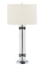 Azelina Table Lamp. Ribbed glass lamp. Silver metal base. Ivory fabric shade. Modern lighting. Contemporary table lamp. Elegant lamp décor. Neutral lighting accessory. Glass and metal lamp. Ambient lighting. Bedroom lamp. Living room table lamp. Designer lighting.