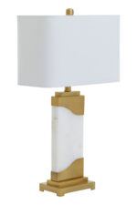 Meadow Table Lamp. Marble Pedestal Lamp. Gold Finish Table Lamp. Ivory Shade Lamp. Contemporary Table Lamp. Boutique Style Lamp. Minimalist Home Lighting. Modern Accent Lamp. Square Shade Lamp. Stylish Living Room Lamp. Desk and Side Table Lamp. Ambient Light Feature. Designer Home Lighting. Luxury Table Lamp. Elegant Interior Lighting.