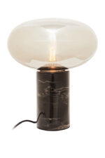 Vega Table Lamp. Black Marble Table Lamp. Gold Cognac Glass Lamp. Cylindrical Marble Lamp. Modern Table Lamp. Luxury Home Lighting. Boutique Style Lamp. Ambient Lighting Feature. Contemporary Table Lamp. Minimalist Desk Lamp. Elegant Side Table Lamp. Statement Home Lighting. Designer Table Lamp. Stylish Living Room Lamp. Durable Accent Lamp.
