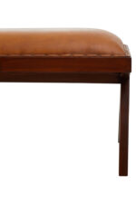 Cadenza Bench With Inverted Base. Tan leather bench. Teak wood base. Inverted V legs. Genuine leather upholstery. Nail head trim. Rustic modern bench. Luxury accent seating. Handcrafted furniture. Vintage-inspired design.