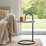 Elaro Hanging Top Side Table. Black Iron Side Table. Grey Round Top Table. Hanging Top Design. Modern Side Table. Minimalist Side Table. Industrial Accent Table. Contemporary Side Table. Round Metal Table. Sculptural Side Table. Sleek Black Frame Table. Durable Iron Table. Compact Accent Table. Living Room Side Table. Bedroom Nightstand Alternative. Modern Home Furniture. Statement Metal Side Table. Functional Accent Table. Industrial Modern Decor. Designer Side Table.