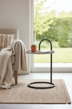 Elaro Hanging Top Side Table. Black Iron Side Table. Grey Round Top Table. Hanging Top Design. Modern Side Table. Minimalist Side Table. Industrial Accent Table. Contemporary Side Table. Round Metal Table. Sculptural Side Table. Sleek Black Frame Table. Durable Iron Table. Compact Accent Table. Living Room Side Table. Bedroom Nightstand Alternative. Modern Home Furniture. Statement Metal Side Table. Functional Accent Table. Industrial Modern Decor. Designer Side Table.