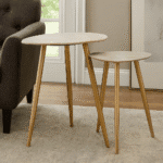 Fiora Set of 2 Shagreen Tables. Shagreen leather tables. Gold finish legs. Round top tables. Modern accent tables. Contemporary side tables. Luxury furniture set. Boutique living room décor. Durable shagreen furniture. Textured finish tables.