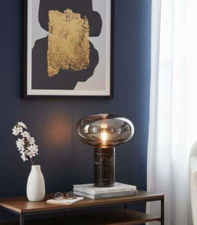 Vega Table Lamp. Black Marble Table Lamp. Gold Cognac Glass Lamp. Cylindrical Marble Lamp. Modern Table Lamp. Luxury Home Lighting. Boutique Style Lamp. Ambient Lighting Feature. Contemporary Table Lamp. Minimalist Desk Lamp. Elegant Side Table Lamp. Statement Home Lighting. Designer Table Lamp. Stylish Living Room Lamp. Durable Accent Lamp.