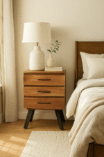 Zuri Acacia Bedside Table. Acacia wood furniture. Black metal legs. Industrial bedside table. Three drawer nightstand. Modern bedroom storage. Contemporary side table. Durable wooden furniture. Minimalist bedside unit. Natural wood design.