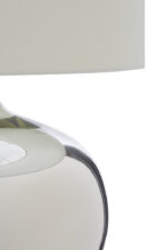 Perrin Ball Shaped Table Lamp. Glass base lamp. Metallic finish lamp. Chrome table lamp. Modern bedside lighting. Contemporary home décor. Elegant living room lamp. White fabric shade. Minimalist glass lighting. Designer accent lamp. Reflective glass lamp. Soft ambient light. Boutique style lamp. Classic meets modern lighting.