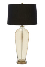 Malden Amber Glass Table Lamp. Amber glass table lamp. Gold base table lamp. Black fabric shade lamp. Luxury glass lighting. Modern amber lamp. Elegant bedside lamp. Contemporary table lamp. Living room lighting. Designer glass lamp. Warm glow lamp. Gold and black table lamp. Sculptural glass base lamp. Decorative lighting. Luxury home décor. Modern classic table lamp. Stylish desk lamp. Glass and metal lamp. Ambient lighting solution. Boutique home lighting.