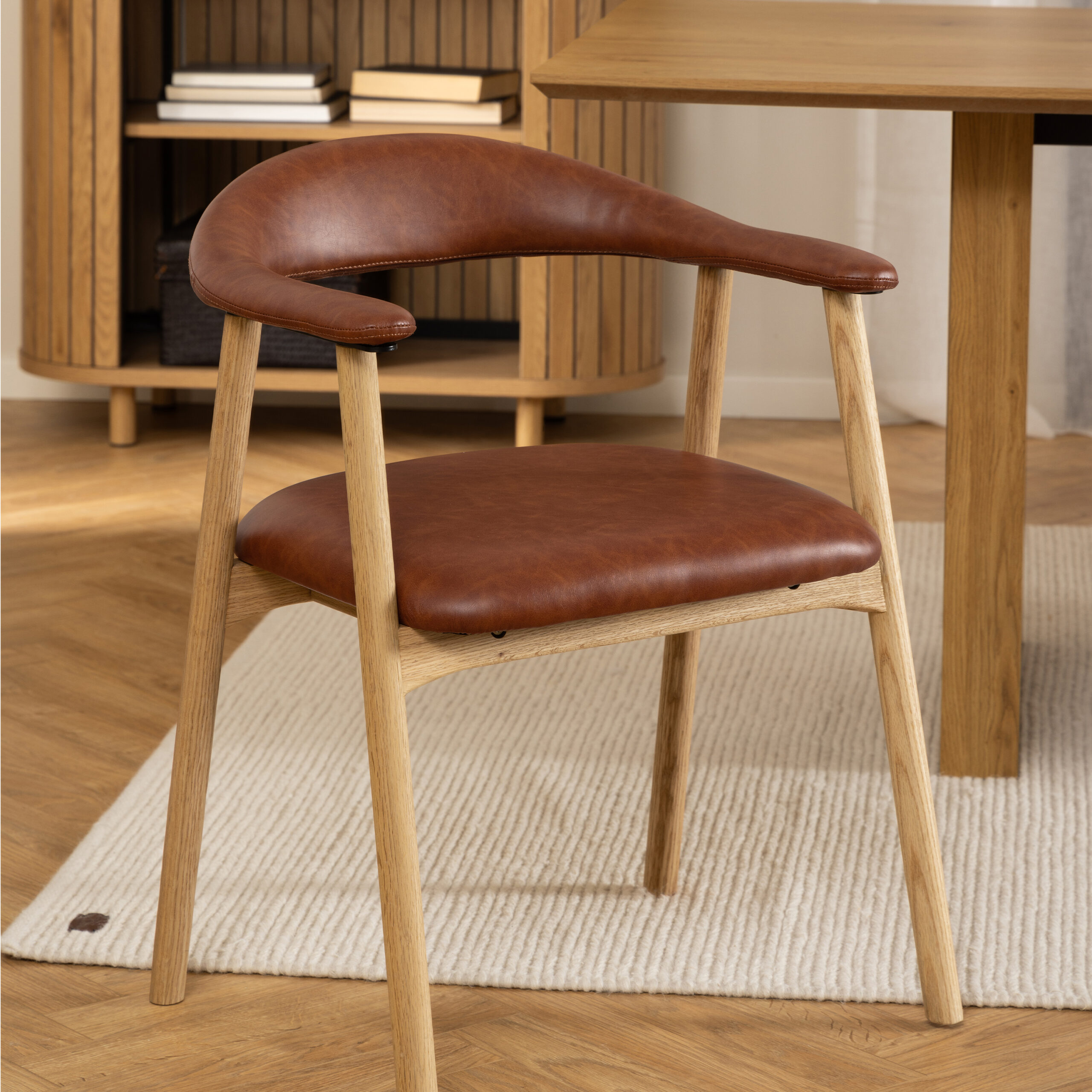 Ari Set of 2 Dining Chairs Ari dining chairs. Set of 2 dining chairs. PU leather dining chair. Oak dining chairs. Scandinavian dining furniture. Modern dining seating. Brandy leather chair. Armrest dining chair. Minimalist dining chair.
