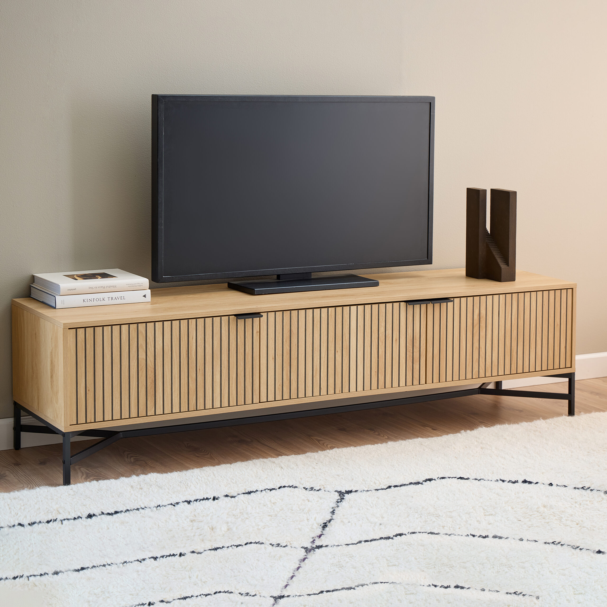 Purino Media Unit Purino Media Unit. Slatted TV unit. Oak effect media unit. Scandinavian TV stand. 180cm TV unit. Modern media console. Black leg TV unit. Light oak TV stand. Living room storage. Contemporary TV furniture.