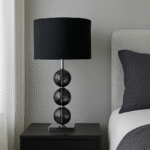 Alora Orb Table Lamp. Chrome table lamp. Glass orb lamp. Cream orb lamp. Black orb lamp. Modern bedside lighting. Elegant home décor. Contemporary table lamp. Reflective base lamp.