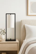 Arvis Iron Frame Table Lamp. Modern table lamp. Black iron lamp. White linen shade lamp. Minimalist lighting. Contemporary home décor. Bedroom table lamp. Living room lighting. Office desk lamp. Modern industrial style lamp. Sleek black metal lamp. Ambient light feature. Designer lamp. Elegant minimalist lighting.