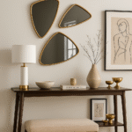 Auro Triangular Wall Mirror. Gold wall mirror. Triangular mirror. Geometric wall décor. Modern gold mirror. Rounded corner mirror. Statement wall accessory. Elegant home décor. Contemporary wall mirror.