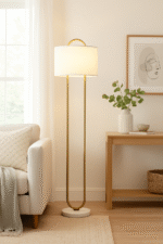 Camden Curved Floor Lamp. Gold floor lamp. White marble base lamp. Curved metal lamp. Modern floor lighting. Luxury home decor. Gold and white lamp. Elegant standing lamp. Minimalist floor light. Contemporary lighting design. Living room lamp. Bedroom floor light. Designer lighting piece. Modern home accessories.