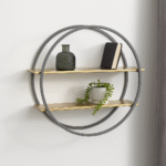 Carlotta Two Tier Wall Shelf. Gold wall shelf. Grey round wall shelf. Modern wall shelving. Geometric wall shelf. Metal wall shelf. Two tier shelf. Contemporary wall decor. Stylish storage shelf. Industrial modern shelf. Matte gold shelves. Circular wall shelf. Decorative shelving.