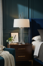 Corey Glass Rods Table Lamp. Art deco table lamp. Silver table lamp. Gold finish lamp. Glass rod lighting. Modern decorative lighting. White or black fabric shade. Luxury home décor lamp. Sculptural metal lamp. Ambient living room lighting. Contemporary bedside table lamp. Reflective metallic base. Designer statement lighting. Boutique interior accessory.