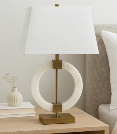 Halden Circular Marble Table Lamp. White marble lamp. Gold base table lamp. Modern marble lighting. Luxury home décor. Brushed gold lamp base. Ivory fabric shade. Contemporary lighting. Sculptural marble lamp. Designer bedside lamp. Elegant living room lighting.