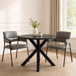 Halvar Round Dining Table. Black wood dining table. Modern dining table. Round dining table. Contemporary dining furniture. Black veneer top. Powder-coated legs. Scandinavian style table. Elegant dining design.