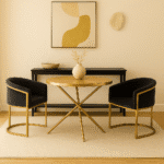 June Dining Table. Dining table with splayed legs. Round dining table. Gold metal base table. Wood top dining table. Sculptural dining table. Luxury dining furniture. Modern dining table. Wooden round table. Contemporary dining room. Gold finish furniture. Minimalist table design. Elegant wood and metal table. Designer round table. Statement dining table. Modern home furniture. Warm metallic base table. Chic dining décor. Contemporary round table. Stylish dining centrepiece.